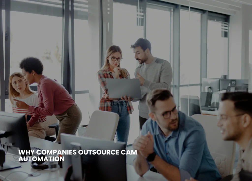 A team of professionals working on laptops and discussing CAM automation strategies in an office setting, representing why companies outsource CAM automation for efficiency and expertise.